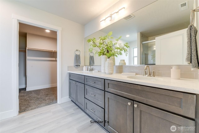 4246 W Sandy Ct, Moses Lake, WA 98837 - full bath featuring double vanity, a shower stall, wood finished floors, a walk in closet, and recessed lighting