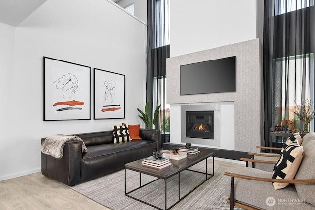 3907 199th Pl SE, Bothell, WA 98012 - living room with wood finished floors, plenty of natural light, a glass covered fireplace, and a towering ceiling