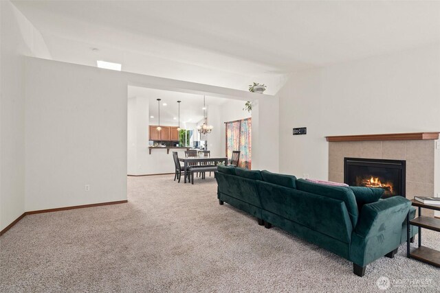 134 Wind River Dr, Chehalis, WA 98532 - living area with carpet, a tile fireplace, baseboards, a chandelier, and lofted ceiling