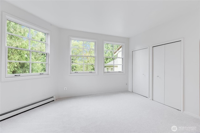 2053 Minor Ave E Unit 12, Seattle, WA 98102 - unfurnished bedroom featuring baseboard heating, multiple windows, and carpet flooring
