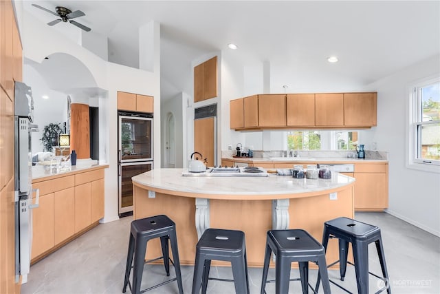 2053 Minor Ave E Unit 12, Seattle, WA 98102 - kitchen with paneled built in fridge, wine cooler, double oven, a kitchen bar, and recessed lighting