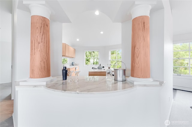 2053 Minor Ave E Unit 12, Seattle, WA 98102 - kitchen with decorative columns, recessed lighting, light brown cabinetry, light countertops, and modern cabinets