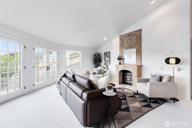 2053 Minor Ave E Unit 12, Seattle, WA 98102 - carpeted living area with plenty of natural light, vaulted ceiling, a fireplace with flush hearth, recessed lighting, and french doors