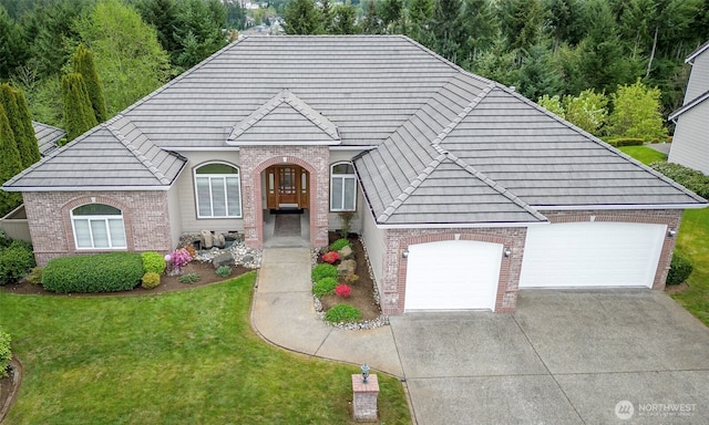 17713 92nd Ave E, Puyallup, WA 98375 - view of front of property with brick siding, a front lawn, driveway, a garage, and a tiled roof