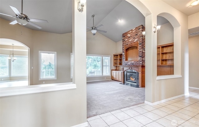 17713 92nd Ave E, Puyallup, WA 98375 - unfurnished living room featuring ceiling fan, carpet floors, tile patterned floors, a large fireplace, and lofted ceiling