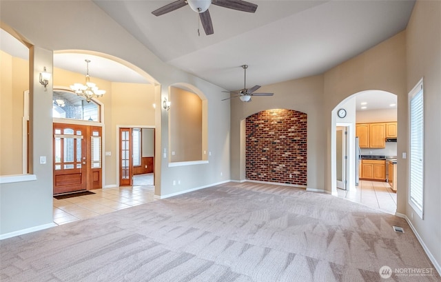 17713 92nd Ave E, Puyallup, WA 98375 - unfurnished living room featuring a ceiling fan, light colored carpet, high vaulted ceiling, arched walkways, and a chandelier