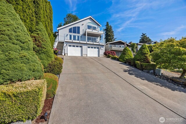 28440 Sound View Dr S, Des Moines, WA 98198 - view of front of property featuring an attached garage, a balcony, concrete driveway, and stairway