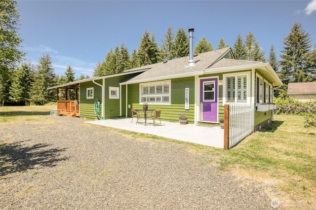 2685 E Hoquiam Rd, Hoquiam, WA 98550 - rear view of property with a patio, roof with shingles, and a lawn