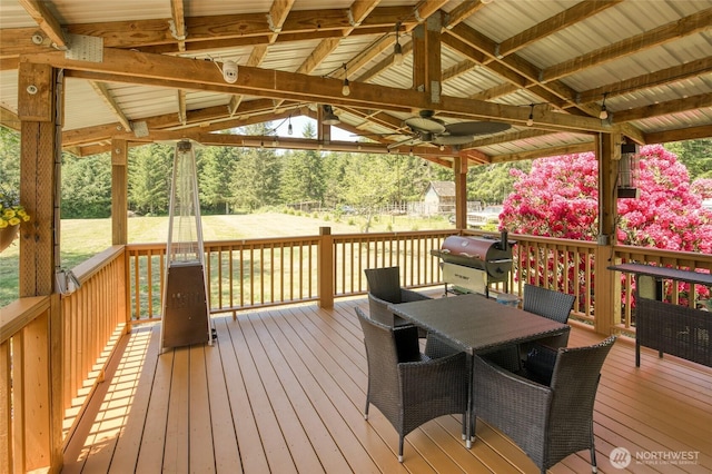 2685 E Hoquiam Rd, Hoquiam, WA 98550 - deck with a ceiling fan, a grill, outdoor dining space, and a gazebo
