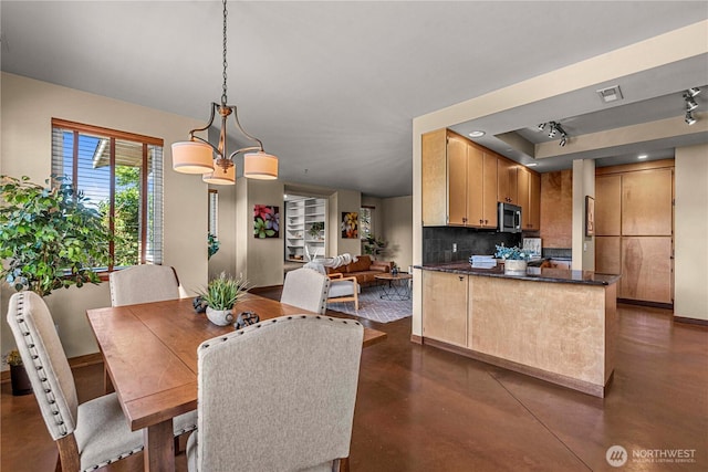 3651 School St, Wenatchee, WA 98801 - dining room with concrete floors, baseboards, and a raised ceiling