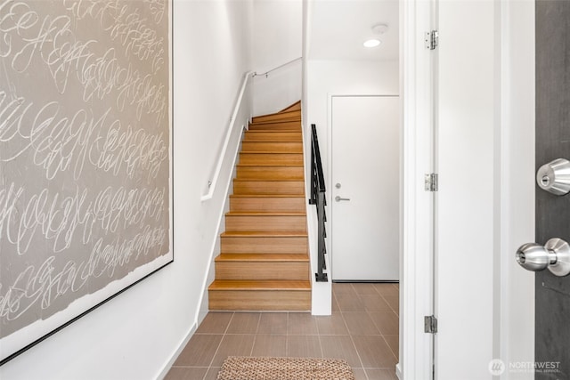 203 20th Ave E, Seattle, WA 98112 - stairway featuring tile patterned floors and baseboards
