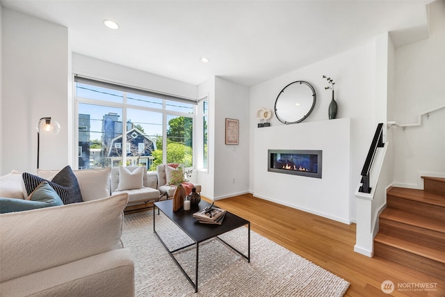 203 20th Ave E, Seattle, WA 98112 - living room featuring wood finished floors, a glass covered fireplace, recessed lighting, stairway, and baseboards