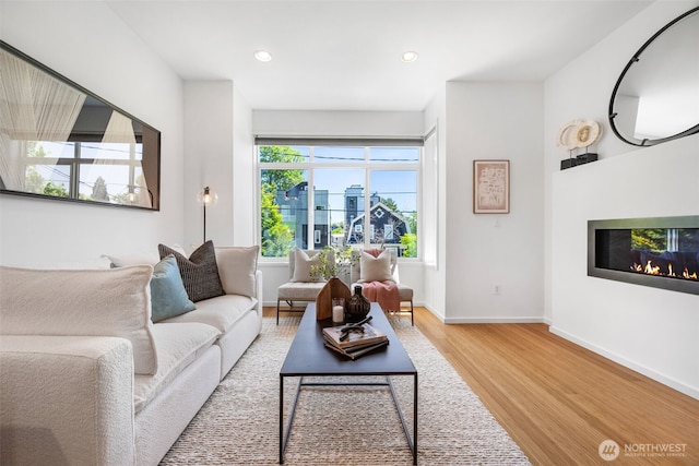 203 20th Ave E, Seattle, WA 98112 - living room with wood finished floors, a glass covered fireplace, recessed lighting, and baseboards