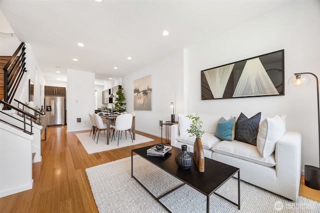 203 20th Ave E, Seattle, WA 98112 - living room with stairway, light wood finished floors, recessed lighting, and baseboards