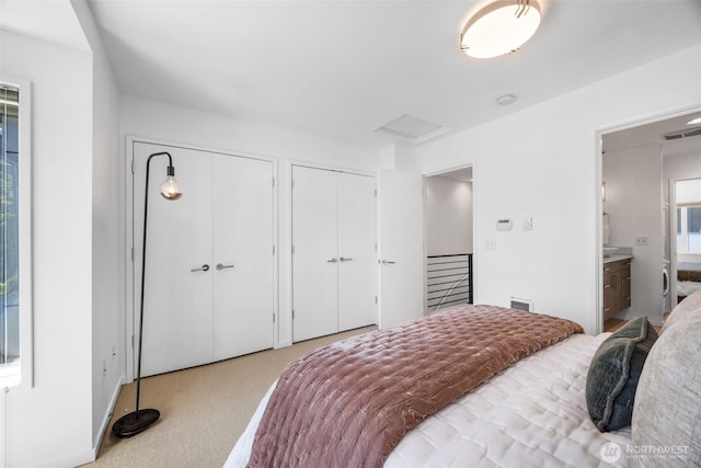 203 20th Ave E, Seattle, WA 98112 - carpeted bedroom with two closets, attic access, and ensuite bathroom