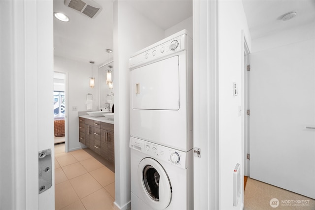 203 20th Ave E, Seattle, WA 98112 - laundry room with stacked washer / drying machine and light tile patterned floors