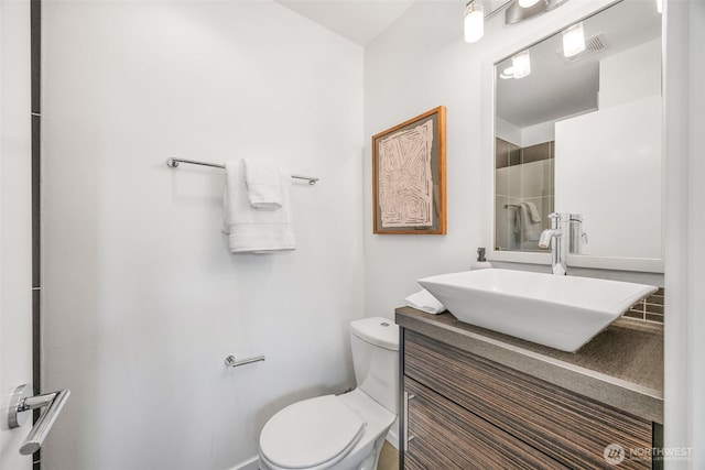 203 20th Ave E, Seattle, WA 98112 - bathroom featuring toilet, vanity, and a tile shower