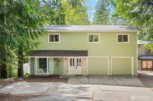 415 Sudden Valley Dr, Bellingham, WA 98229 - view of front facade with roof with shingles, driveway, and an attached garage
