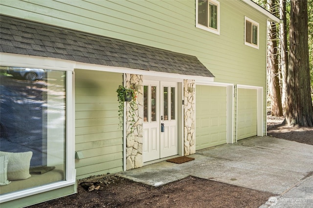 415 Sudden Valley Dr, Bellingham, WA 98229 - entrance to property featuring an attached garage, a shingled roof, concrete driveway, and stone siding