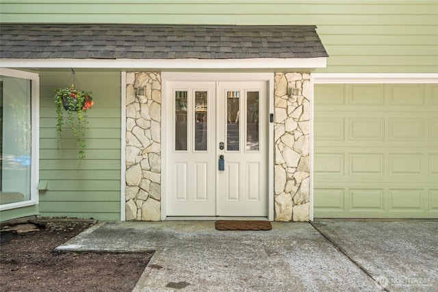 415 Sudden Valley Dr, Bellingham, WA 98229 - property entrance with stone siding, roof with shingles, and a garage