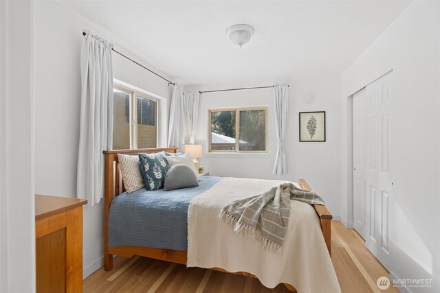 415 Sudden Valley Dr, Bellingham, WA 98229 - bedroom featuring light wood-style flooring, baseboards, and a closet