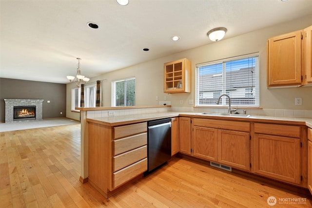 4109 Shale St SE, Lacey, WA 98503 - kitchen featuring stainless steel dishwasher, a sink, a peninsula, light wood-style flooring, and a chandelier