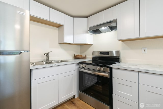10405 12th Avenue Ct S, Tacoma, WA 98444 - kitchen with stainless steel appliances, ventilation hood, and white cabinets