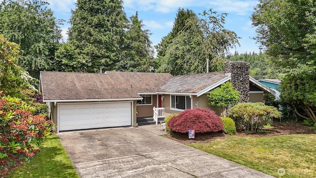 209 Old Hill Rd, Aberdeen, WA 98520 - ranch-style home with concrete driveway, an attached garage, stucco siding, a front lawn, and a chimney