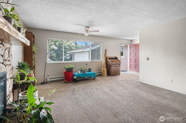 209 Old Hill Rd, Aberdeen, WA 98520 - carpeted living room with a fireplace, a ceiling fan, a textured ceiling, and a baseboard heating unit