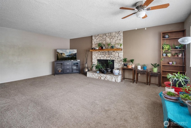 209 Old Hill Rd, Aberdeen, WA 98520 - living room featuring a ceiling fan, carpet floors, a fireplace, and a textured ceiling