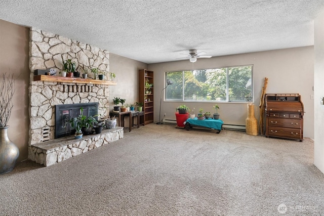 209 Old Hill Rd, Aberdeen, WA 98520 - carpeted living room with ceiling fan, a baseboard heating unit, a fireplace, and a textured ceiling