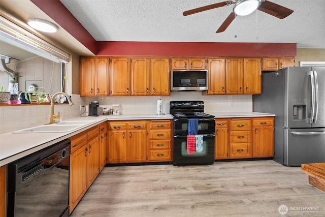 209 Old Hill Rd, Aberdeen, WA 98520 - kitchen featuring black appliances, brown cabinetry, backsplash, ceiling fan, and a textured ceiling