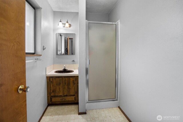 209 Old Hill Rd, Aberdeen, WA 98520 - full bath with a shower stall, a textured ceiling, vanity, and tile patterned floors