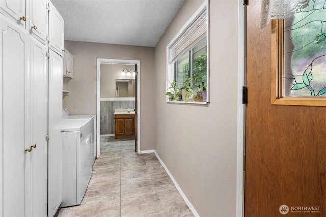 209 Old Hill Rd, Aberdeen, WA 98520 - laundry area with washer and dryer, cabinet space, and a textured ceiling