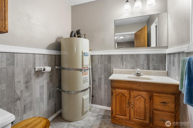 209 Old Hill Rd, Aberdeen, WA 98520 - half bath featuring strapped water heater, vanity, and wainscoting