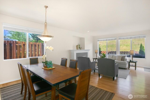 27638 246th Ave SE, Maple Valley, WA 98038 - dining room with light wood finished floors, healthy amount of natural light, and a fireplace