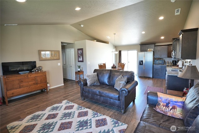 1028 W Sequoia Rd, Moses Lake, WA 98837 - living room featuring vaulted ceiling, dark wood-type flooring, recessed lighting, and baseboards