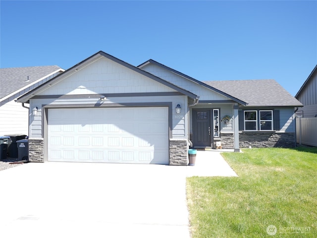 1028 W Sequoia Rd, Moses Lake, WA 98837 - single story home featuring an attached garage, concrete driveway, stone siding, and a front lawn