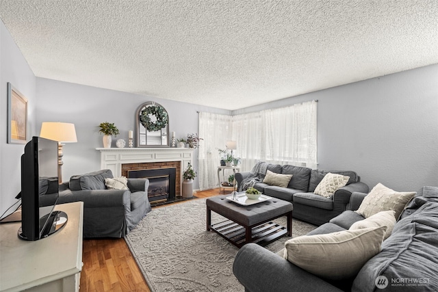 2112 SE Yucca Ct, Port Orchard, WA 98366 - living room featuring a textured ceiling, wood finished floors, and a fireplace