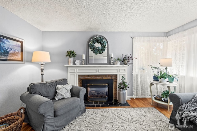 2112 SE Yucca Ct, Port Orchard, WA 98366 - living area with wood finished floors, a textured ceiling, and a fireplace