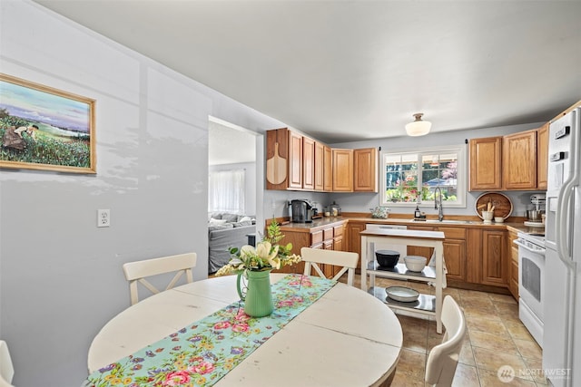 2112 SE Yucca Ct, Port Orchard, WA 98366 - kitchen with white stove, a sink, light countertops, and light tile patterned floors