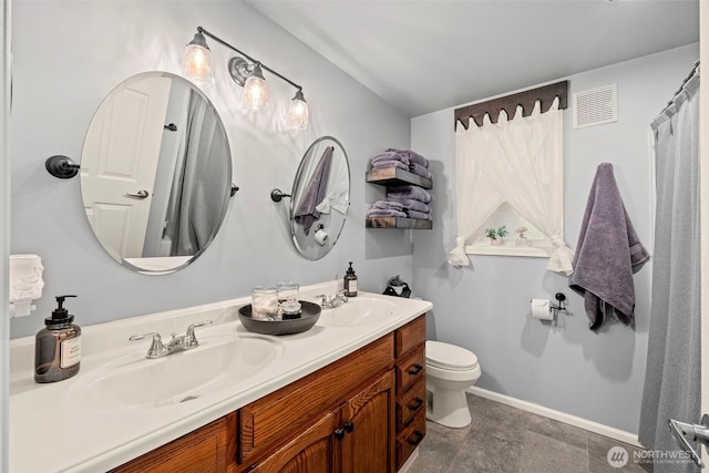 2112 SE Yucca Ct, Port Orchard, WA 98366 - bathroom featuring toilet, double vanity, and baseboards