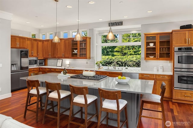8418SE 44th St, Mercer Island, WA 98040 - kitchen featuring stainless steel appliances, brown cabinets, decorative backsplash, light countertops, and recessed lighting
