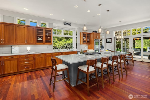 8418SE 44th St, Mercer Island, WA 98040 - kitchen with double oven, light countertops, dark wood-type flooring, brown cabinets, and a sink