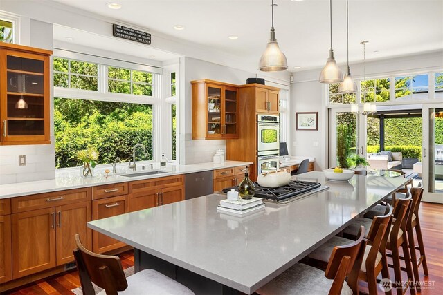 8418SE 44th St, Mercer Island, WA 98040 - kitchen with a sink, appliances with stainless steel finishes, brown cabinetry, light countertops, and recessed lighting