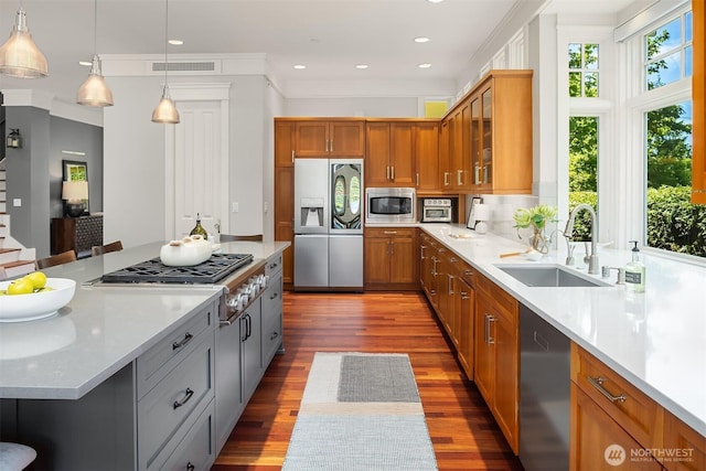 8418SE 44th St, Mercer Island, WA 98040 - kitchen featuring appliances with stainless steel finishes, a sink, brown cabinetry, wood finished floors, and glass insert cabinets