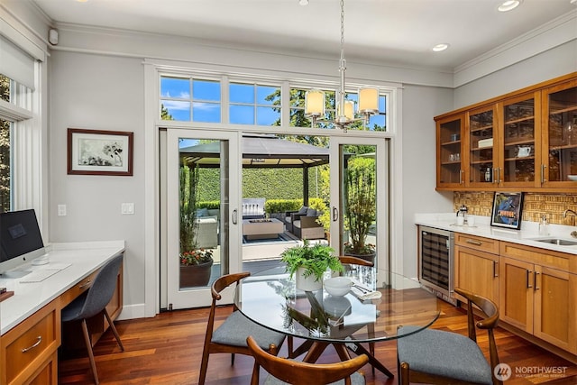 8418SE 44th St, Mercer Island, WA 98040 - dining room with beverage cooler, healthy amount of natural light, crown molding, a chandelier, and dark wood-type flooring