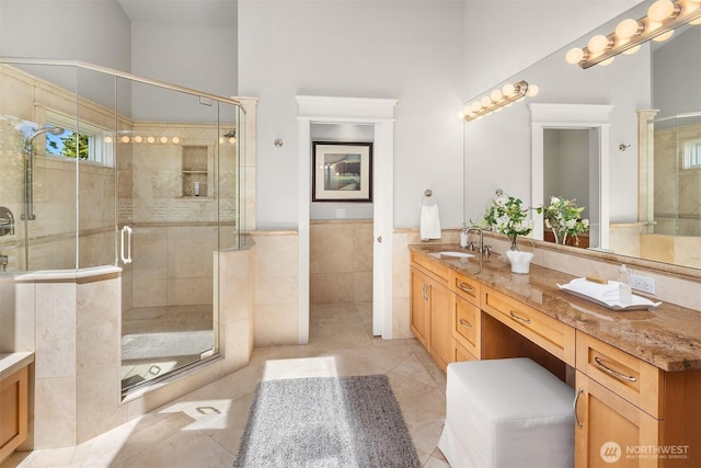 8418SE 44th St, Mercer Island, WA 98040 - bathroom featuring tile walls, double vanity, tile patterned flooring, a shower stall, and wainscoting