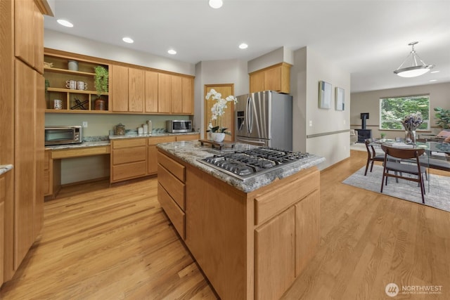 6117 Ames Lake Carnation Rd NE, Carnation, WA 98014 - kitchen featuring stainless steel appliances, built in desk, light wood-type flooring, a kitchen island, and open shelves