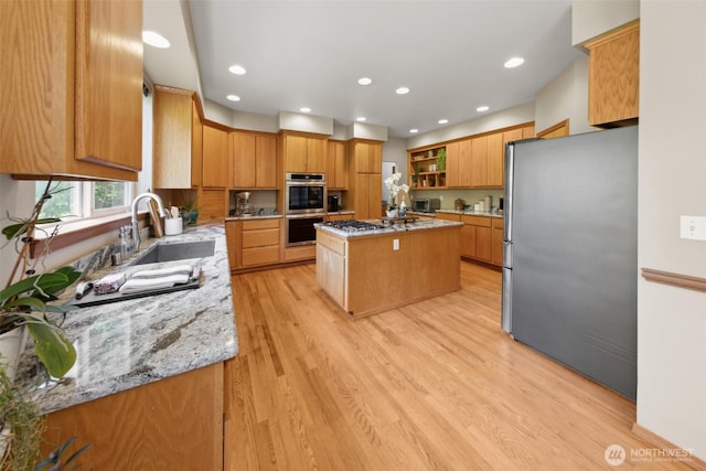 6117 Ames Lake Carnation Rd NE, Carnation, WA 98014 - kitchen with appliances with stainless steel finishes, light stone counters, light wood-type flooring, a center island, and open shelves
